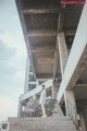 A woman standing on the steps of a concrete building.