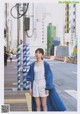 A woman standing in the middle of a city street.