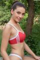 A woman in a red and white bikini posing for a picture.