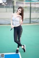 A woman holding a tennis racket on a tennis court.